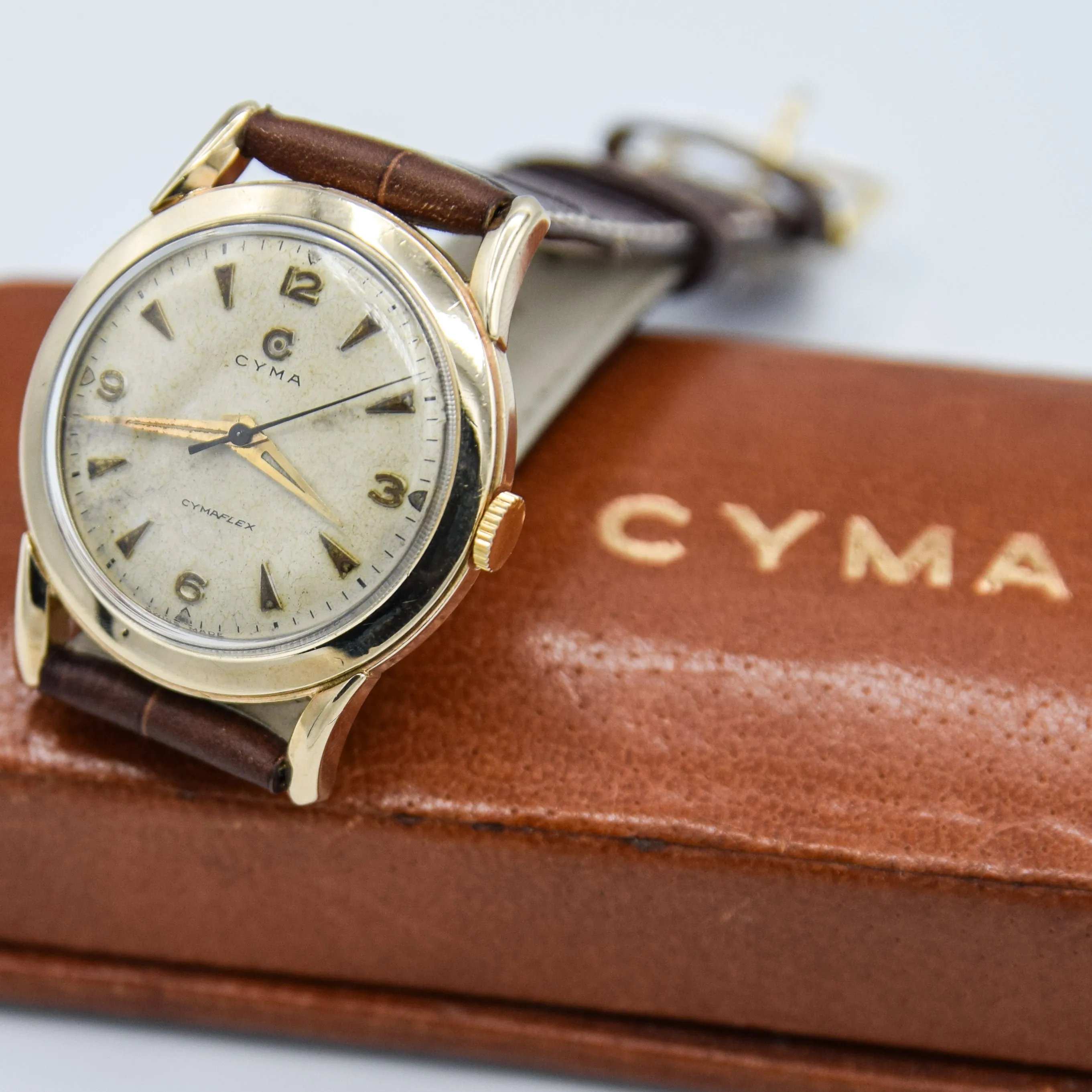 1954 Cyma Cymaflex Wristwatch Bombe Style Lugs and Mixed Arabic and Arrow Batons in Solid 9ct Gold with Original Box